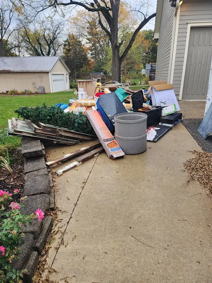 Dumpster being loaded with debris for 12 Yard Dumpster Rental in Falfurrias